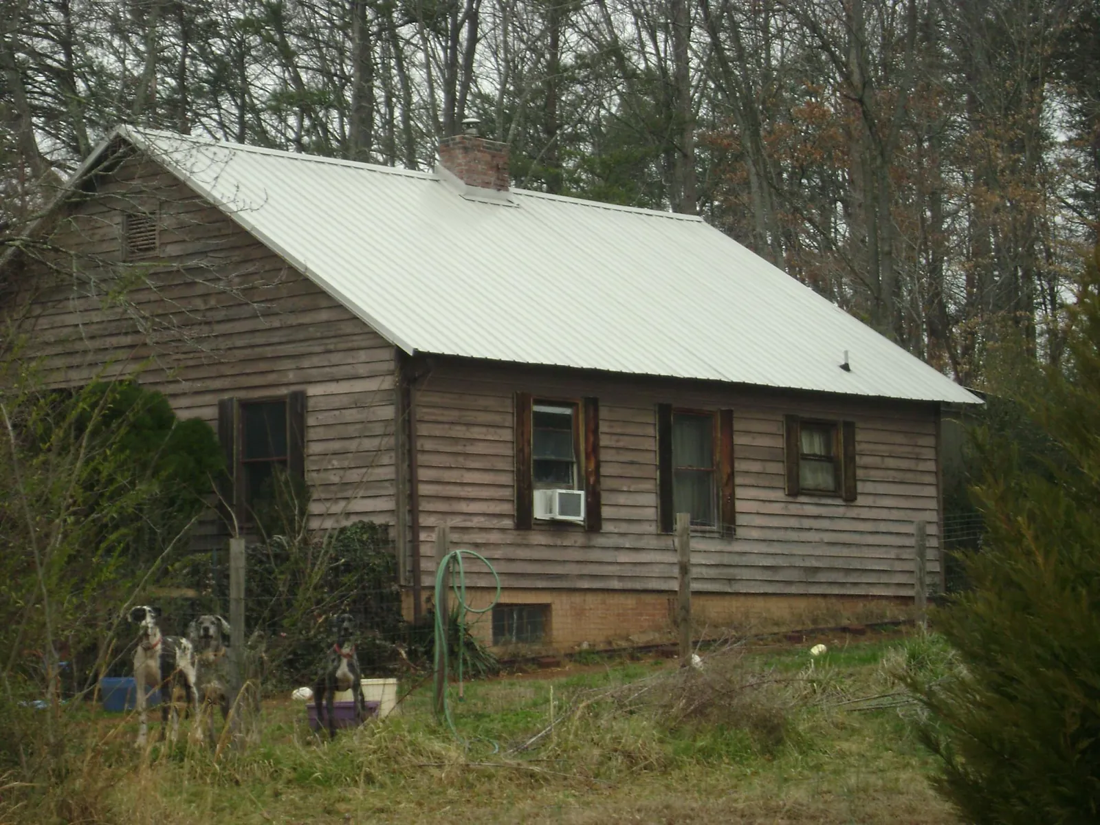 White metal roof on an old wood sided farmhouse, from a Metal Roof Installation job in Goochland
